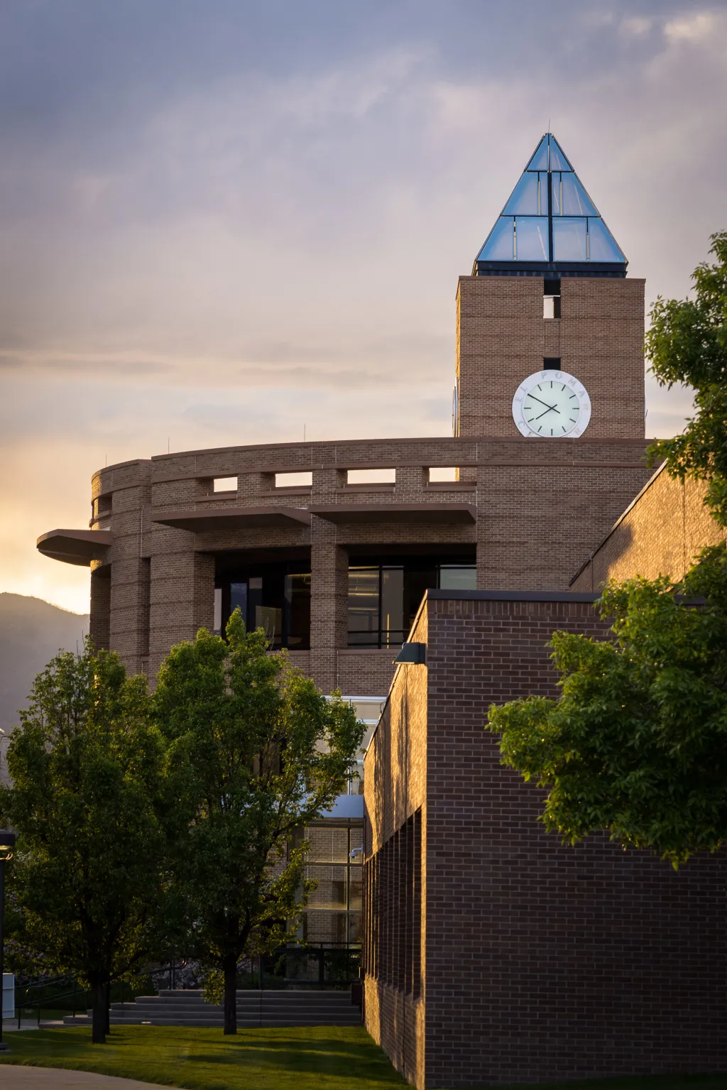 photo of el pomar center clock tower on UCCS campus at sunset